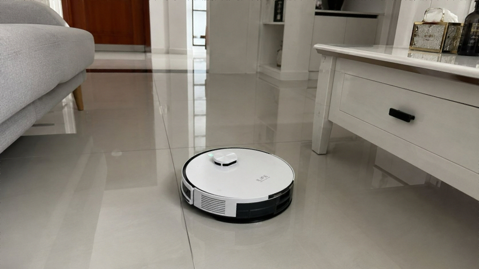 ILIFE A30 Pro robot vacuum with self-emptying station on hardwood floor